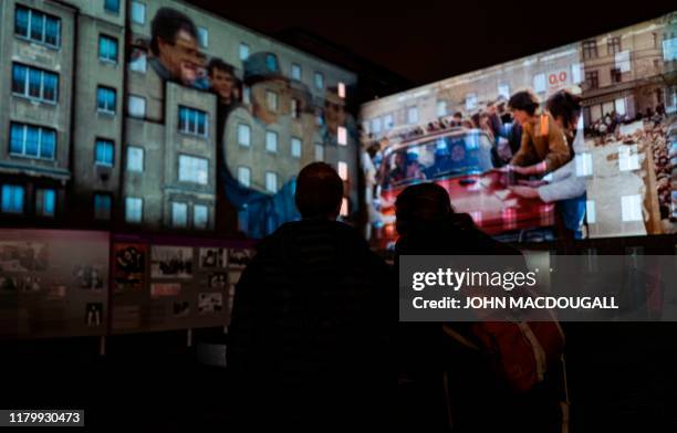 Footage showing east German crossing into west Germany is projected on the walls of the former Stasi headquarters during the city-wide kick-off of...