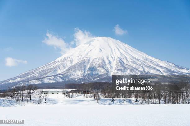 beautiful landscape view of little fuji mountain yotei and village near niseko hokkaido japan - vulkan yotei stock-fotos und bilder