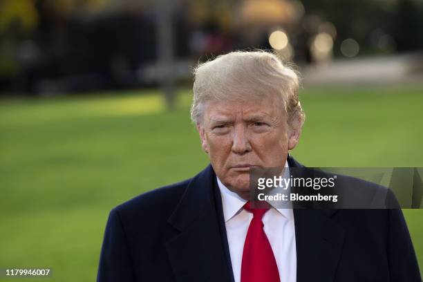President Donald Trump pause while speaking to members of the media before boarding Marine One on the South Lawn of the White House in Washington,...