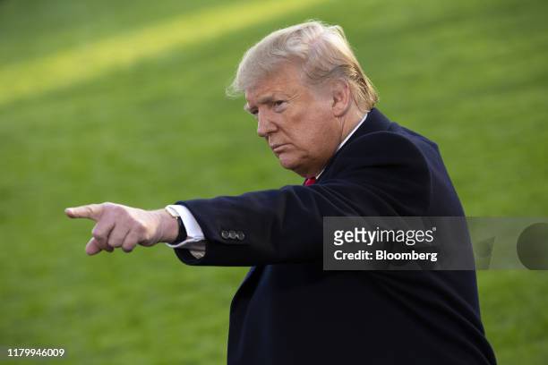 President Donald Trump points to members of the media before boarding Marine One on the South Lawn of the White House in Washington, D.C., U.S., on...