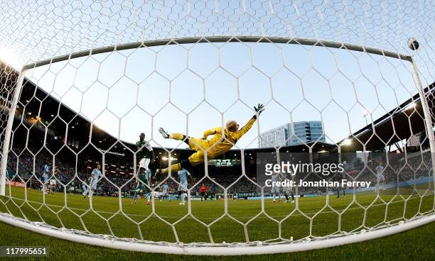 Goalkeeper Jimmy Neilsen of Sporting Kansas City dives to stop a goal score by Darlington Nagbe of the Portland Timbers on July 2, 2011 at Jeld-Wen...