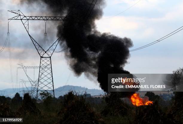 Black smoke billows from fire at a gas pipeline of Petroleos Mexicanos which exploded while being repaired by employees of the state oil company...
