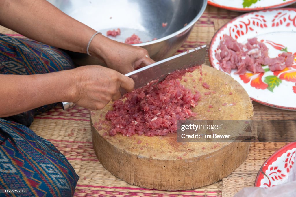 Woman making Isan food.