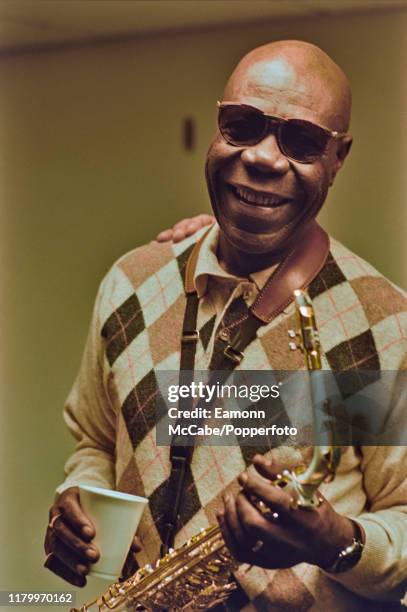 Cameroonian afrobeat musician Manu Dibango posed with saxophone in London circa 2000.