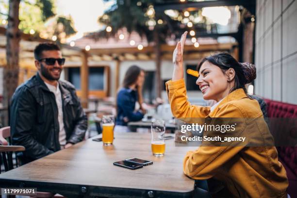 people sitting outdoors in pub - café esplanada imagens e fotografias de stock
