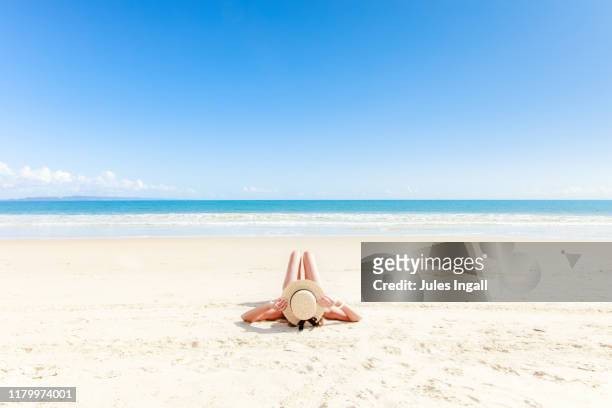 girl laying on the beach - noosa beach stock pictures, royalty-free photos & images