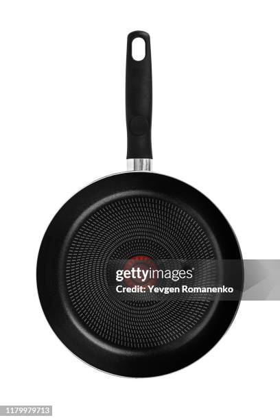 black frying pan with a non-stick teflon coating, isolated over the white background - pfanne stock-fotos und bilder