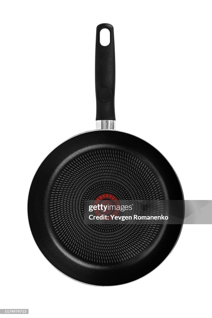 Black frying pan with a non-stick teflon coating, isolated over the white background