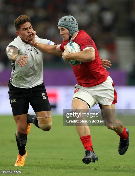 Jonathan Davies of Wales fends off Jale Vatubua of Fiji during the Rugby World Cup 2019 Group D game between Wales and Fiji at Oita Stadium on...