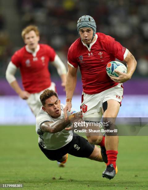 Jonathan Davies of Wales breaks past Jale Vatubua of Fiji during the Rugby World Cup 2019 Group D game between Wales and Fiji at Oita Stadium on...