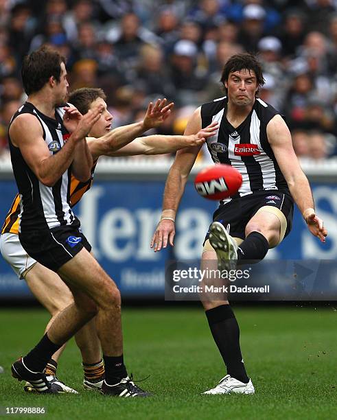 Leigh Brown of the Magpies snaps a goal during the round 15 AFL match between the Collingwood Magpies and the Hawthorn Hawks at Melbourne Cricket...