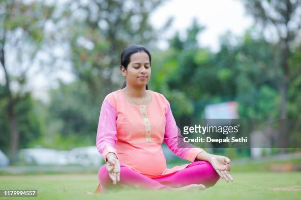 pregnant woman's sitting in a position lotus stock photo - south india stock pictures, royalty-free photos & images
