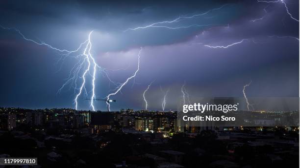 lightning over the city during a heavy thunderstorm - brisbane storm stock pictures, royalty-free photos & images