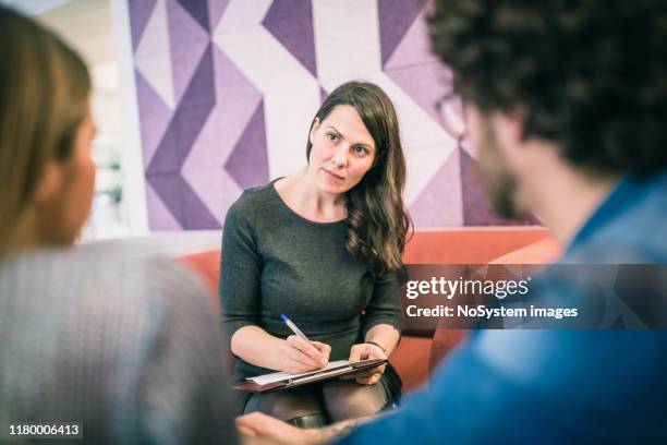 couple on meeting with counsellor - alcohol dependency stock pictures, royalty-free photos & images