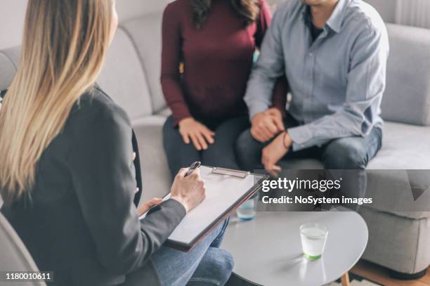 expecting couple on home counselling meeting - young couple talking stock pictures, royalty-free photos & images