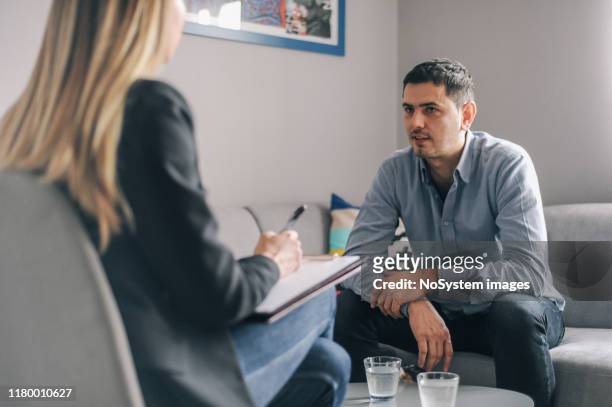 mid age man having on on one counselling meeting - mental health professional stock pictures, royalty-free photos & images