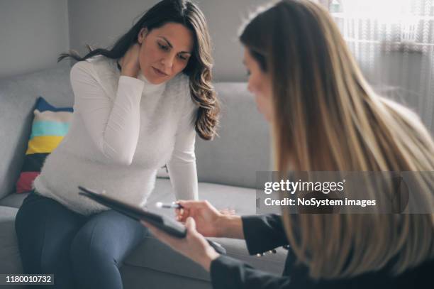 pregnant woman on home counselling meeting - genetic counselling stock pictures, royalty-free photos & images