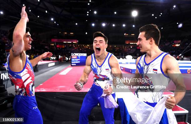 Artur Dalaloyan, Nikita Nagornyy and David Belyavskiy of Russia celebrate Gold during the Men's Team Final on Day 6 of FIG Artistic Gymnastics World...