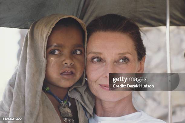 British actress and humanitarian Audrey Hepburn with an Ethiopian girl on her first field mission for UNICEF in Ethiopia, 16th-17th March 1988.