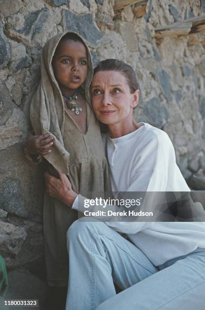 British actress and humanitarian Audrey Hepburn with an Ethiopian girl on her first field mission for UNICEF in Ethiopia, 16th-17th March 1988.