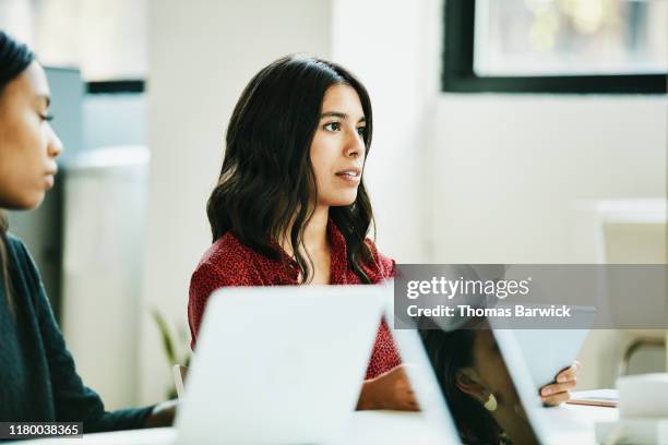 Businesswoman leading team meeting in office conference room