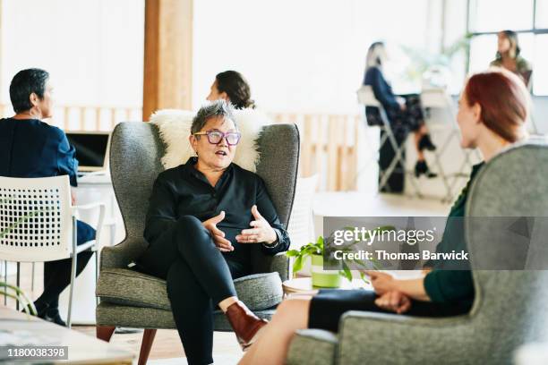 senior businesswoman in meeting with client in coworking office - filipino ethnicity and female not male fotografías e imágenes de stock