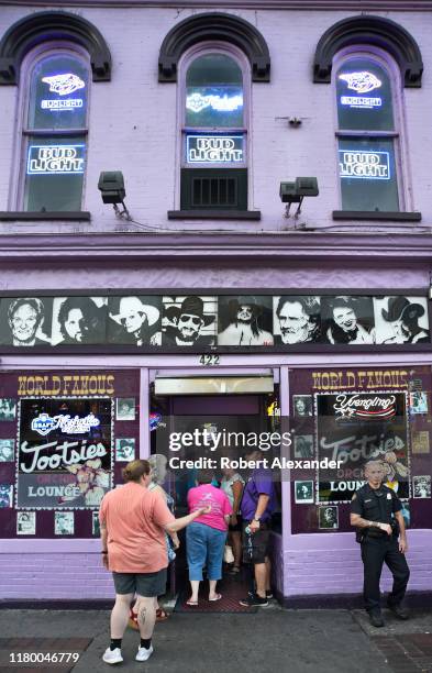 Tourists enter Tootsie's Orchid Lounge, an iconic bar and live country music venue in the Lower Broadway entertainment district in Nashville,...