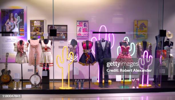 An exhibit of stage costumes and musical instruments worn and played by country music singer Kacey Musgraves at the Country Music Hall of Fame and...