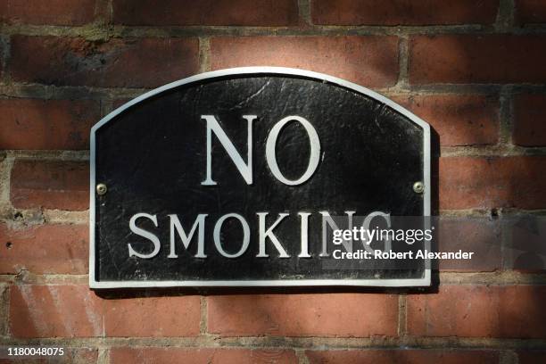 No Smoking' sign on the side of a brick building in downtown Nashville, Tennessee.