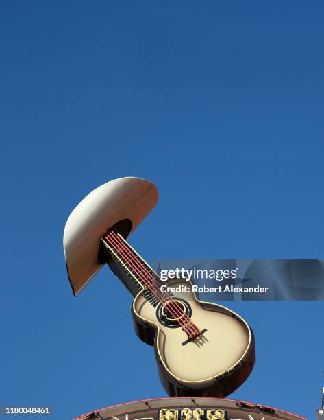 Neon sign above the entrance to The Stage bar and live music venue in Nashville, Tennessee, features a cowboy hat and a guitar.