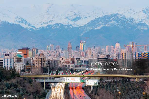 elevated view of the skyline of tehran from the nature bridge looking north towards the mountains - tehran skyline stock pictures, royalty-free photos & images