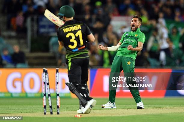 Pakistan's paceman Mohammad Amir celebrates the wicket of Australia's David Warner during the second Twenty20 match between Australia and Pakistan at...