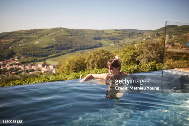 woman in pool - camping de lujo fotografías e imágenes de stock