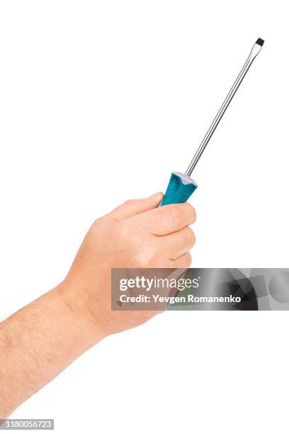 hand holding a slotted screwdriver isolated on white background - destornillador fotografías e imágenes de stock