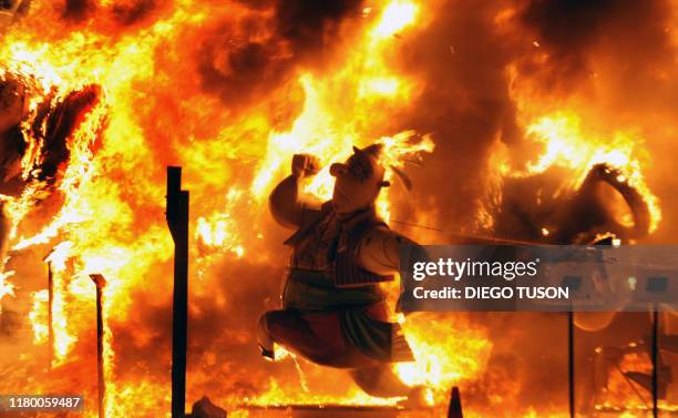 Ninot" sculpture burns during the last day of the "Fallas" festival in Valencia on March 19, 2008. The Fallas festival is a week of fireworks and...