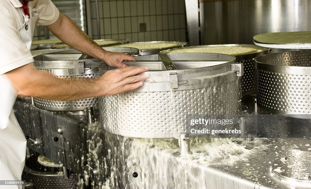 Estrujar la leche de queso de cuajada en la prensa