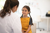 Girl Receiving Check up with the Doctor stock photo