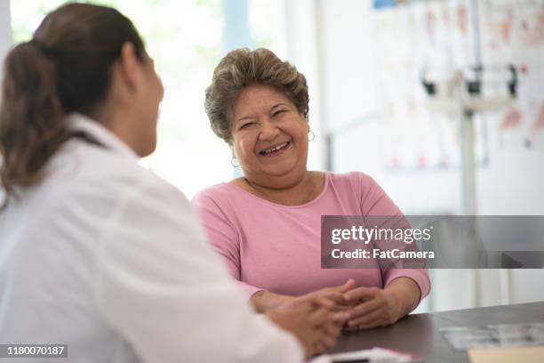 older woman talking with the doctor stock photo - clinic canada diversity imagens e fotografias de stock