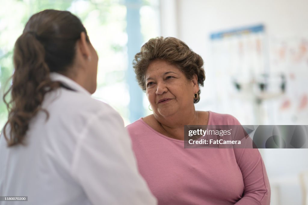 Older Woman talking with the Doctor stock photo