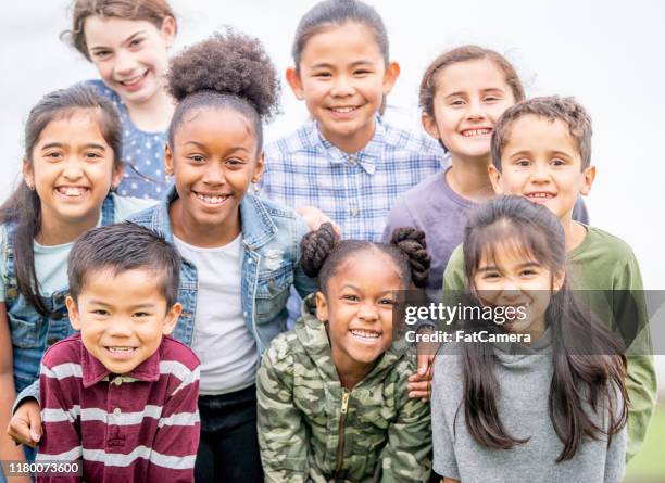 multi-ethnic group of children outside foto d'archivio - child mental health wellness foto e immagini stock