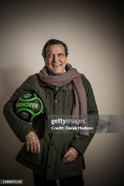 Portrait of former German Chancellor Gerhard Schroder as he poses with a Hannover 96 soccer ball under his arm, Hannover, Germany, March 15, 2018. He...