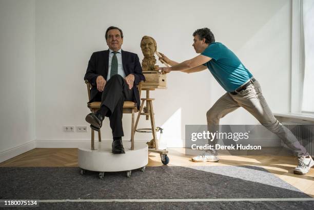Former German Chancellor Gerhard Schroder poses for sculptor Bertrand Freiesleben, the latter making finishing touches to clay bust , Hannover,...