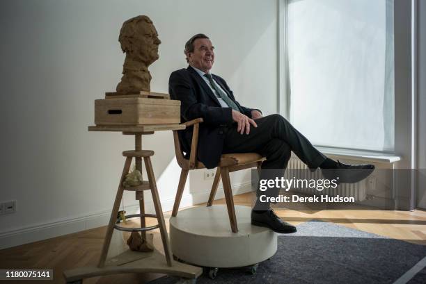 Former German Chancellor Gerhard Schroder poses for sculptor Bertrand Freiesleben, the latter making finishing touches to clay bust , Hannover,...