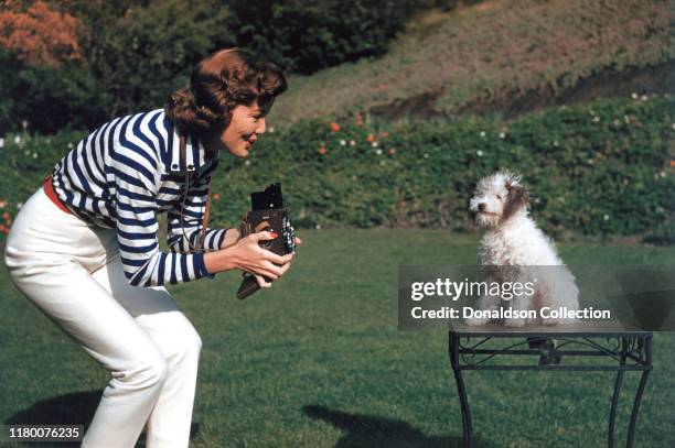 Nanette Fabray plays with her dog at home circa 1959.