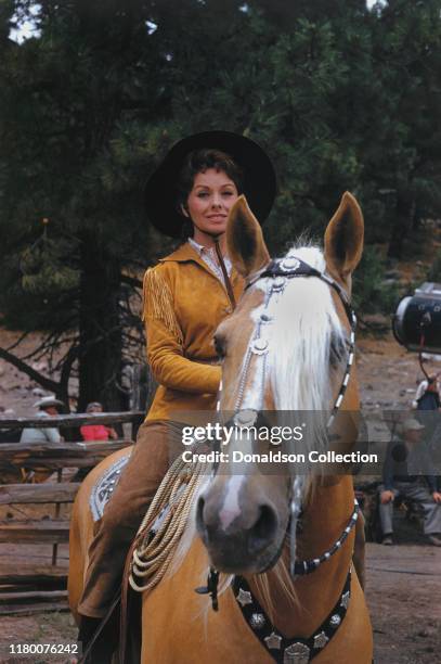 Jeanne Crain rides a horse in circa 1959.