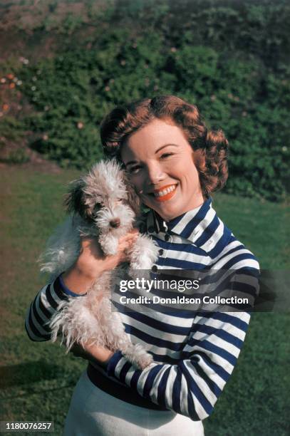 Nanette Fabray plays with her dog at home circa 1959.