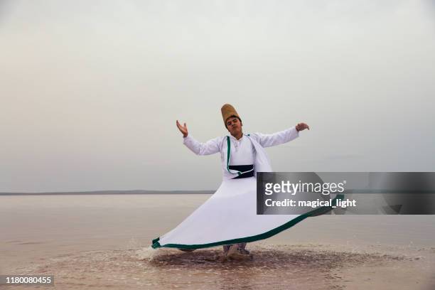sunset and whirling at the sea, sufi. sufi whirling (turkish: semazen) is a form of sama or physically active meditation which originated among sufis. - sufism imagens e fotografias de stock