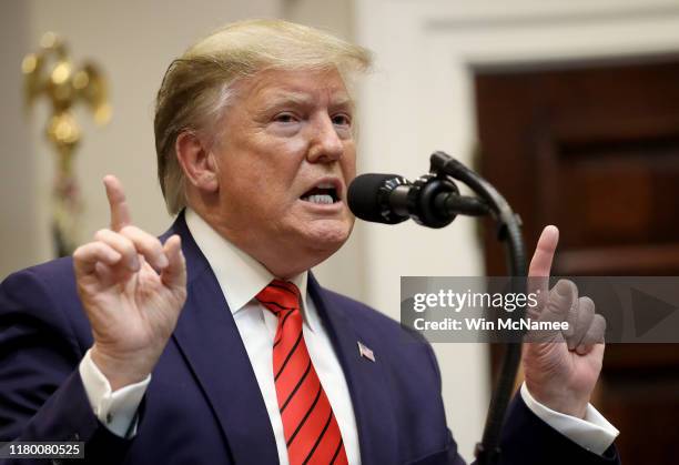 President Donald Trump responds to a question from a reporter at an event for the signing of two executive orders aimed at greater governmental...