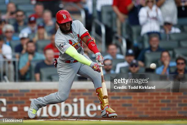 Marcell Ozuna of the St. Louis Cardinals hits an RBI single against the Atlanta Braves during the first inning in game five of the National League...