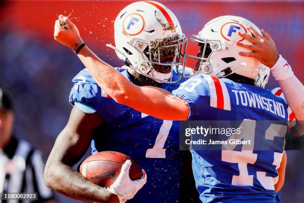 Jeremiah Moon of the Florida Gators celebrates a turnover with teammate Tommy Townsend during the third quarter of a game against the Auburn Tigers...